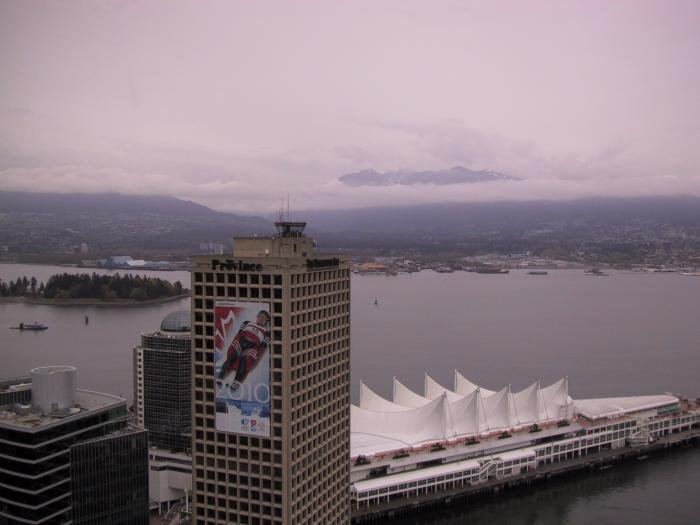 Grouse Mountain breaking through the thick clouds.